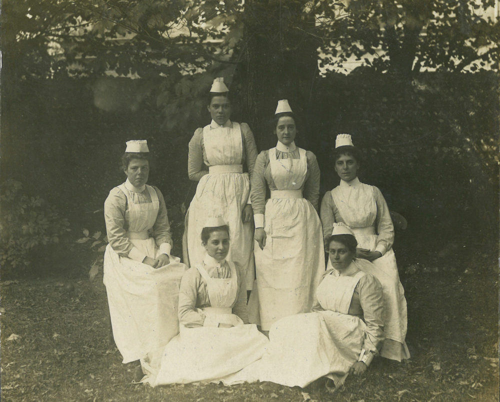 A group of six nurses in uniform, late 19th century